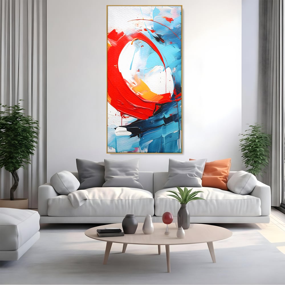 Tablou canvas cu pictura abstracta cu cerc rosu si tuse albastre, in rama de aluminiu auriu, pe perete intr-un living